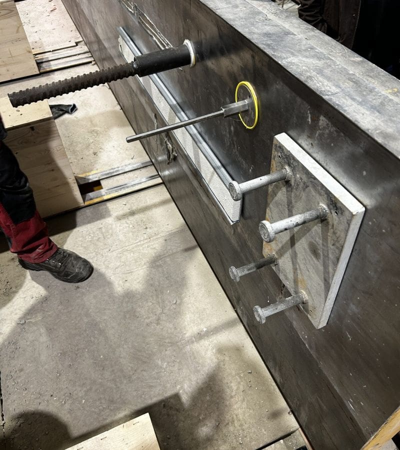 Precast form inserts attached to a metal panel with Casttec adhesives