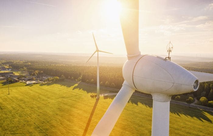 Beautiful Sunset Above wind turbines in a field