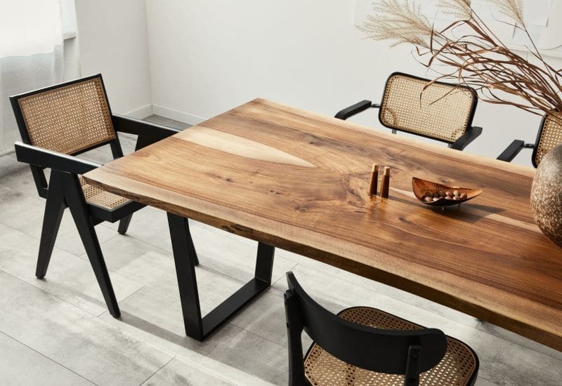 Large modern looking dining table with ornate chairs around it