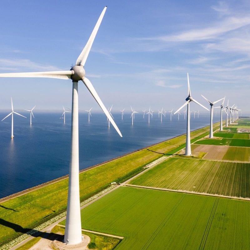 Windmills Turbines And A Blue Sky Generating Electricity Green Energy
