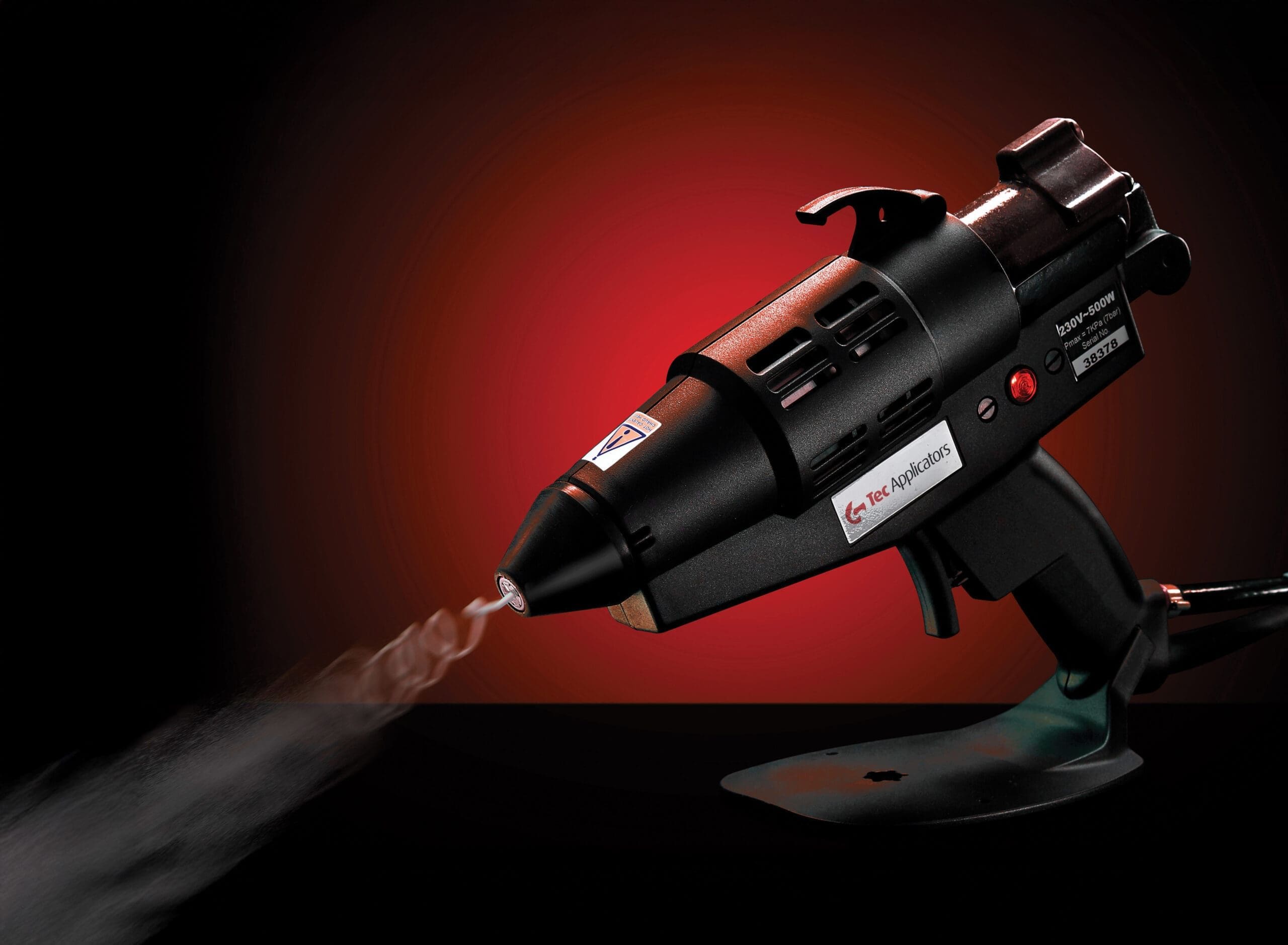 Tec 6300 spray glue gun on a red and black background