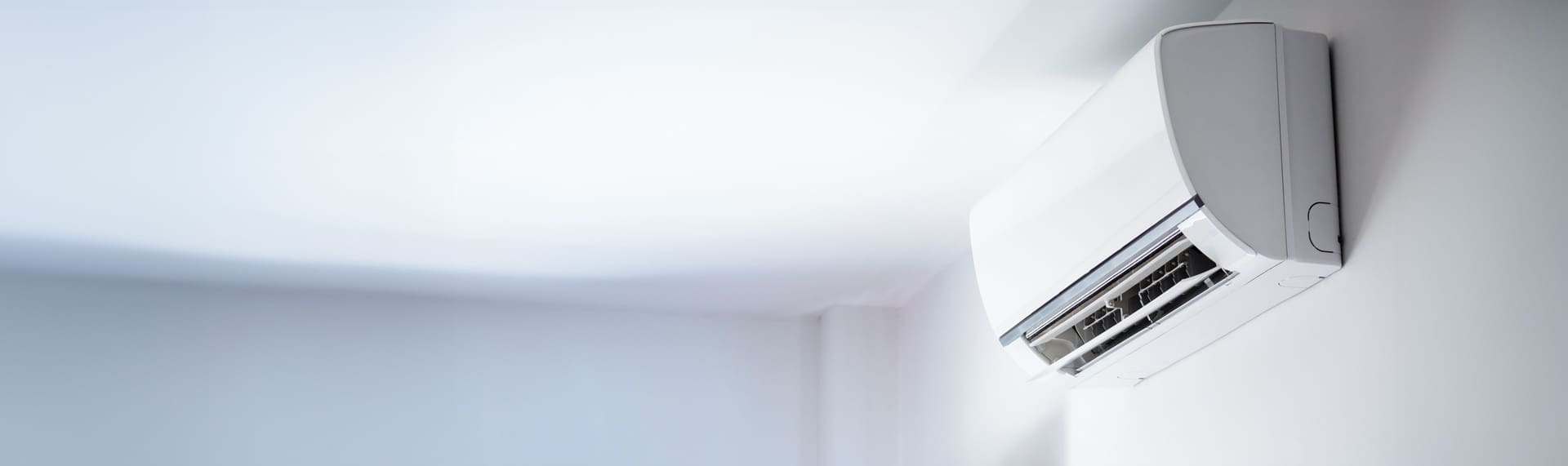 Air conditioning unit mounted to top of wall