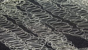 Spray pattern from a Tec hot melt glue gun on a dense dark foam
