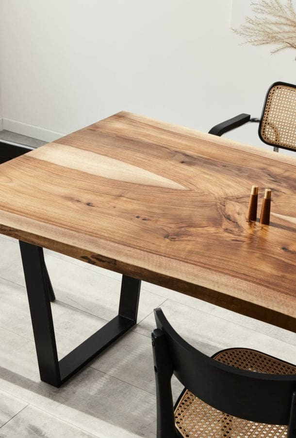 Large modern looking dining table with ornate chairs around it