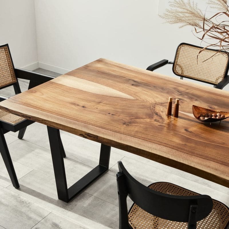 Large modern looking dining table with ornate chairs around it