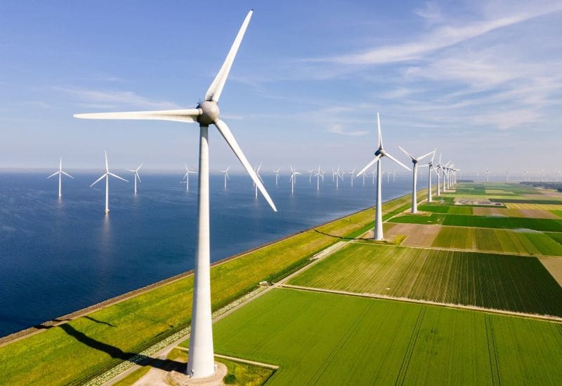 Windmills Turbines And A Blue Sky Generating Electricity Green Energy