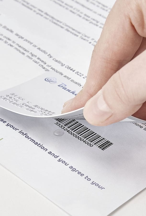 Person removing credit card for the bottom of a letter