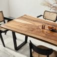 Large modern looking dining table with ornate chairs around it