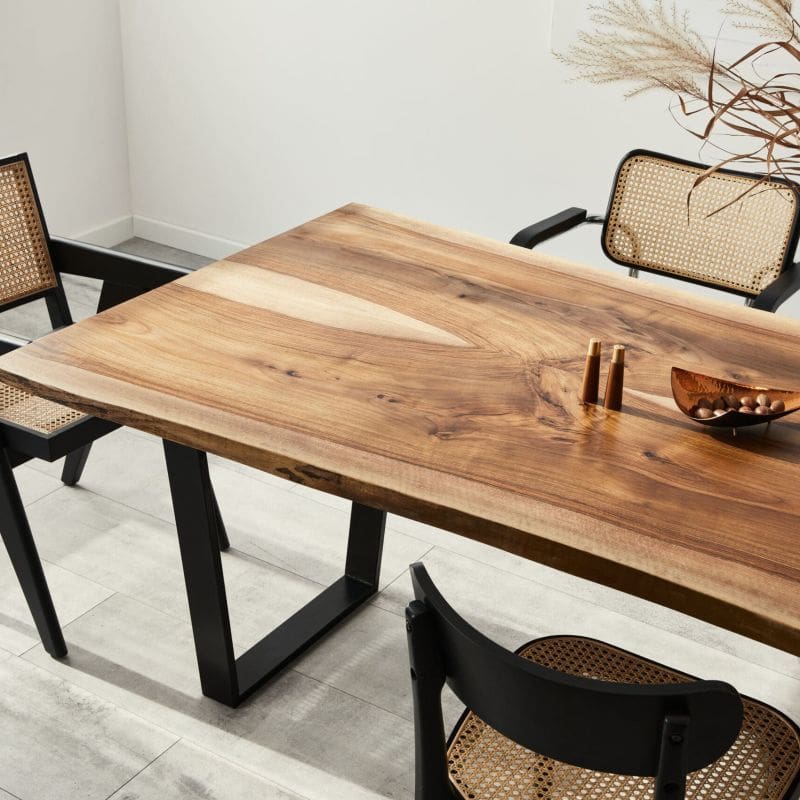 Large modern looking dining table with ornate chairs around it